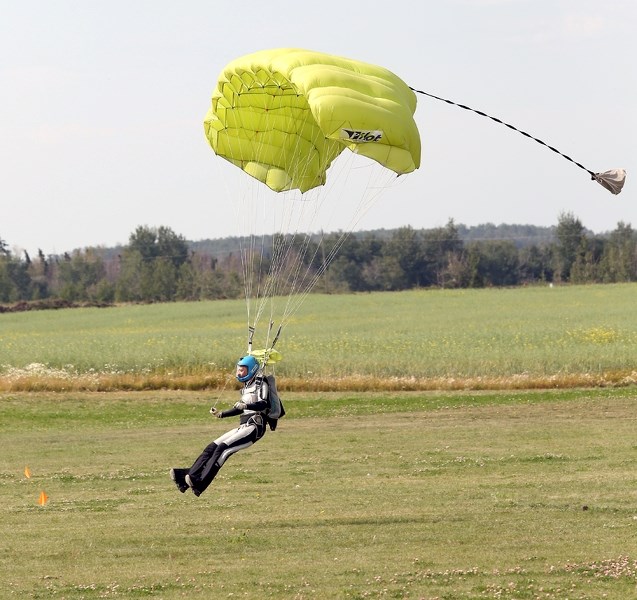 Skydiver Zivile Gudaityte, from Lithuania, comes in for a landing, one of more than 30 skydivers who landed during the tail end of the Aug. 11 fly-in breakfast.