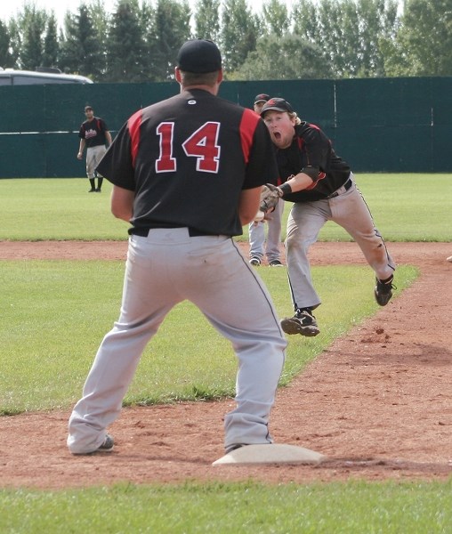 Red Lions second baseman Jordan Brand flips a ball to first baseman Adam Sawatzky during the club’s 3-2 Sunday win at Keller Field over the Camrose Axemen in Game 3 of the