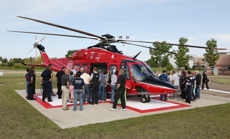 Westlock firefighters, hospital staff and onlookers gather around STARS’ new AW139 helicopter during a publicity tour and training session on Aug. 23 at the Westlock Health