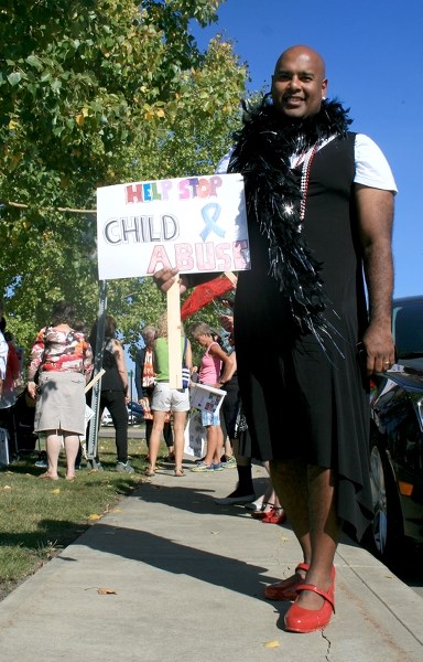 Westlock ATB Financial branch manager Anthony Ferdinand wore a dress and red heels to the first-ever Walk a Mile Her Shoes event held on Friday in Westlock.