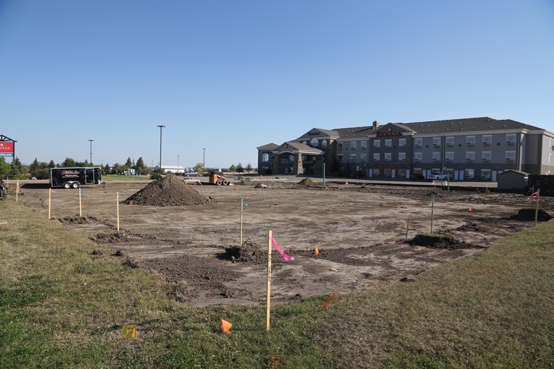 This empty hole between the Westlock Ramada and Boston Pizza will soon be a Tim Hortons. The location is slated to open in early 2014, but could start serving customers as