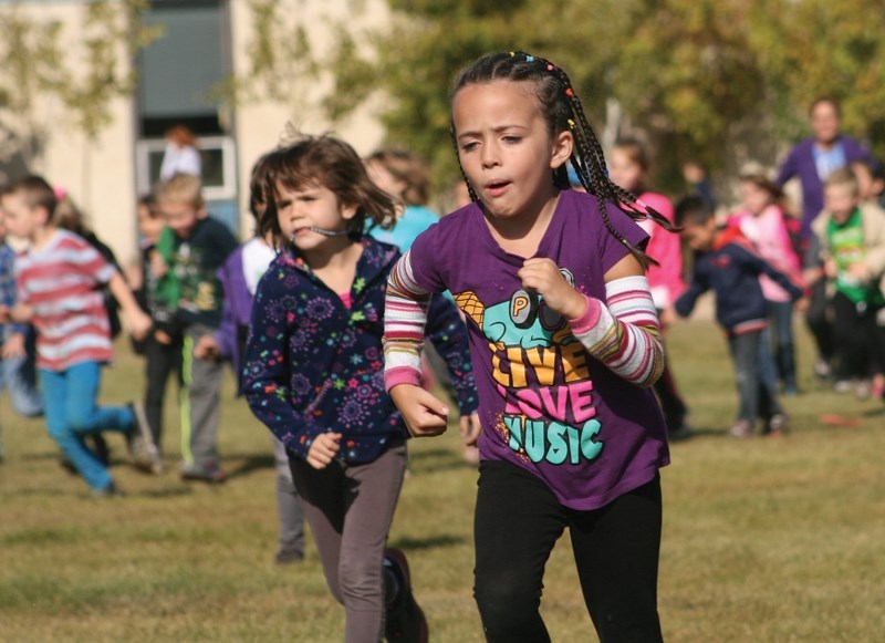 Westlock Elementary School Grade 1 students Avery Lee and Arianne MacAulay sprint away from pack.