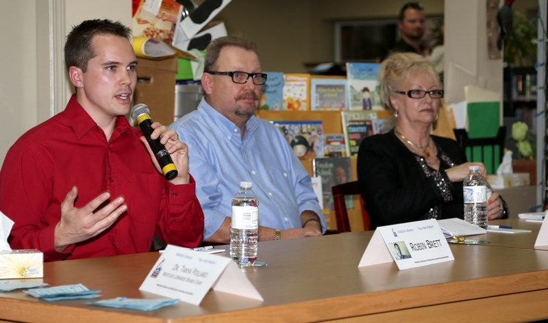 Westlock mayoral candidate Robin Brett (left) answers a question during the Oct. 3 mayoral forum at the Westlock Library. Waiting their own questions are Ralph Leriger and
