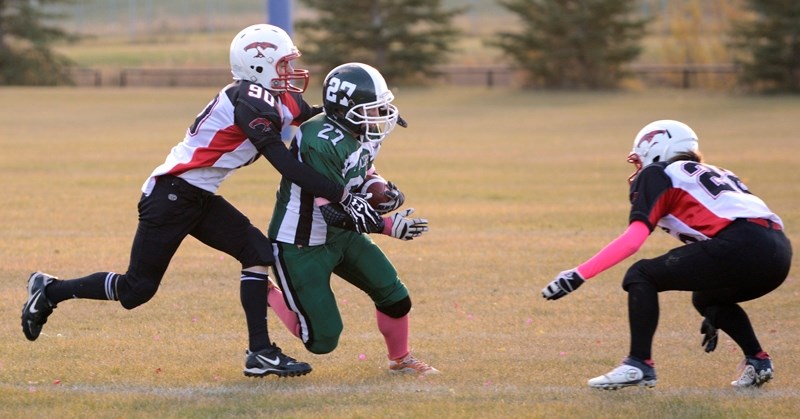 Westlock Thunderbirds Ronald Spiker (left) and Valerie McMillan move in to tackle an Athabasca Pacers receiver during Thursday’s away game in Athabasca. The game ended in a