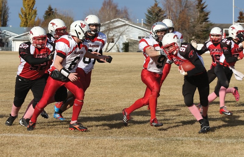 Westlock Thunderbird Zach Kiselyk (91) muscles his way through the Vermilion Marauders’ defence to score a touchdown in the third quarter of the teams’ playoff game Oct. 19