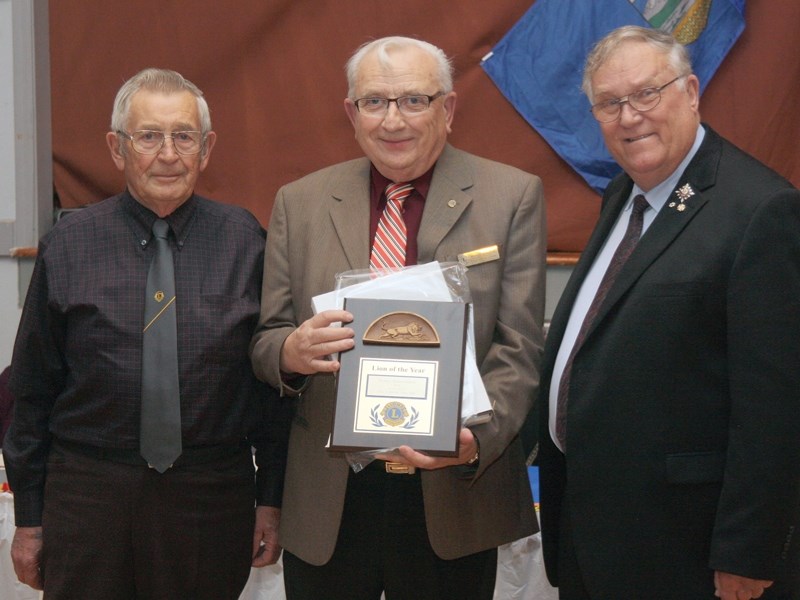 Lions member John Roska and Lt.-Gov. Donald S. Ethell present the Lion of the Year award to president Henry Romanchuk during the Vimy Lions fall supper on Oct. 19. Ian Shank