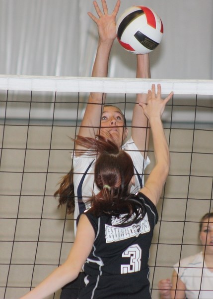 Lilly Artemenko jumps to block a shot by an opposing Thorhild player on Saturday.