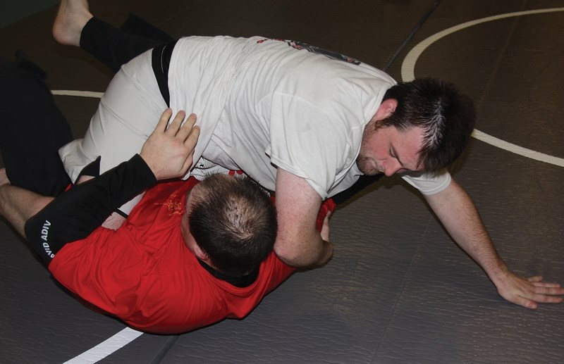 Paul Lanouette and Ryan Flear practice submission wrestling moves at the Westlock Rotary Spirit Centre on Saturday. The Westlock Grappling Club is a new group that meets on