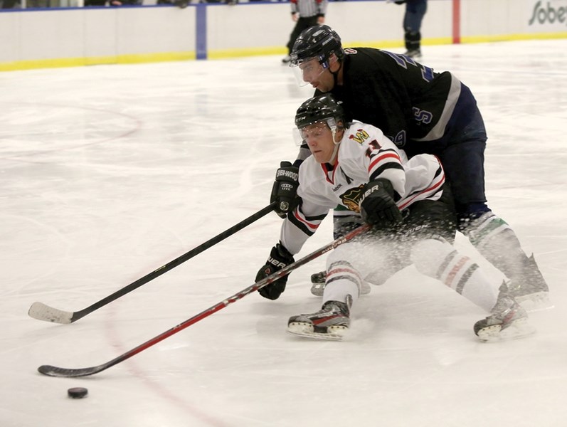 Westlock Warrior Evan Kuhar fights to maintain control of the puck as he drives on net in the third period of the team’s home game against the Drayton Valley Wildcats on Nov. 