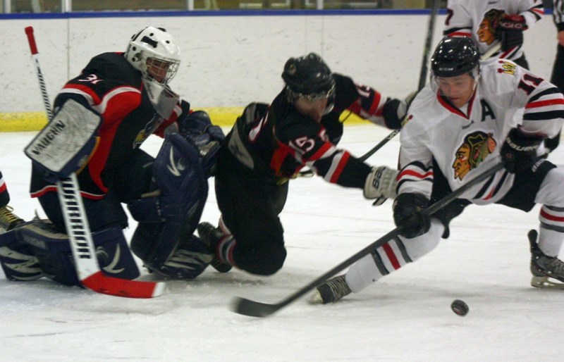 The Westlock Warriors’ Evan Kuhar fights for the puck in front of the Slave Lake Winterhawks’ net during a Friday night tilt, which Westlock won 4-3 after scoring three goals 