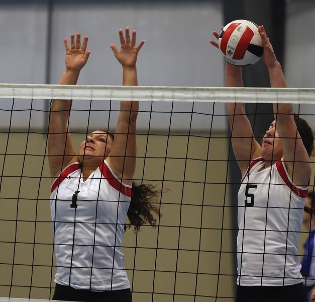Senior girls T-Birds Amelia Kulmatyski (left) and Sydney Toma go up for a block against Barrhead on Nov. 16 at the Westlock Rotary Spirit Centre, with Toma getting the most
