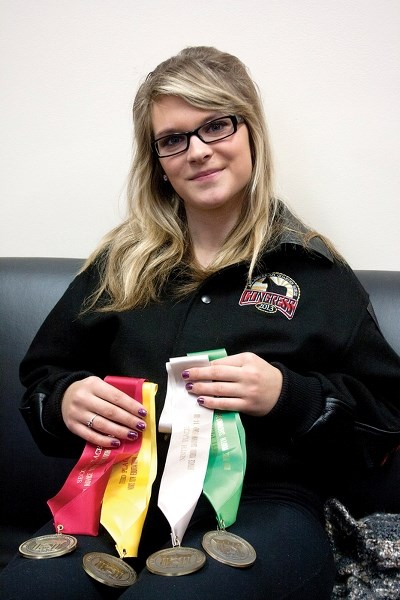 Busby’s Hayley Watt displays the hardware she won at the 2013 All American Quarter Horse Congress which ran Oct. 2-27 in Columbus, Ohio.