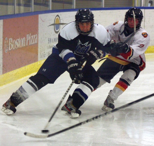 Westlock’s Spencer Blades chases an Edmonton NWZ Lightning defender around the back of the net during the gold-medal game of the Gord Smith Memorial Midget Tournament held