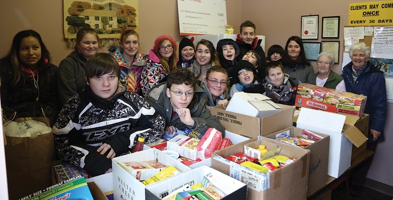 Lisa Albrecht’s (third from right) Grade 7 class at Eleanor Hall brought more than 200 kilograms of food to the Westlock Food Bank on Dec. 11. The entire student body at the