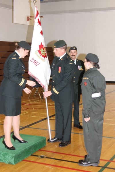 Capt. Pat Neilson (centre) takes the Westlock Cadet Corps flag away from Capt. Amanda Race (left) as Capt. Rick Thibault and warrant officer Christine Ashton look on during a 