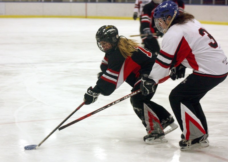 Jordan Neuls chases after Taite Broadhurst during an exhibition match between the St. Albert Knockout and the St. Albert Sonics in Westlock last Saturday night. The teams