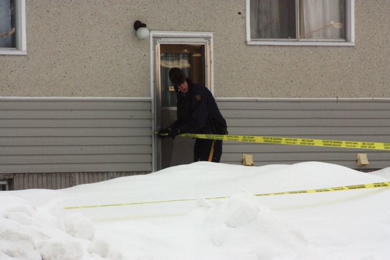 A Westlock RCMP officer taped off an area outside a Southview home after a body was discovered Jan. 6.