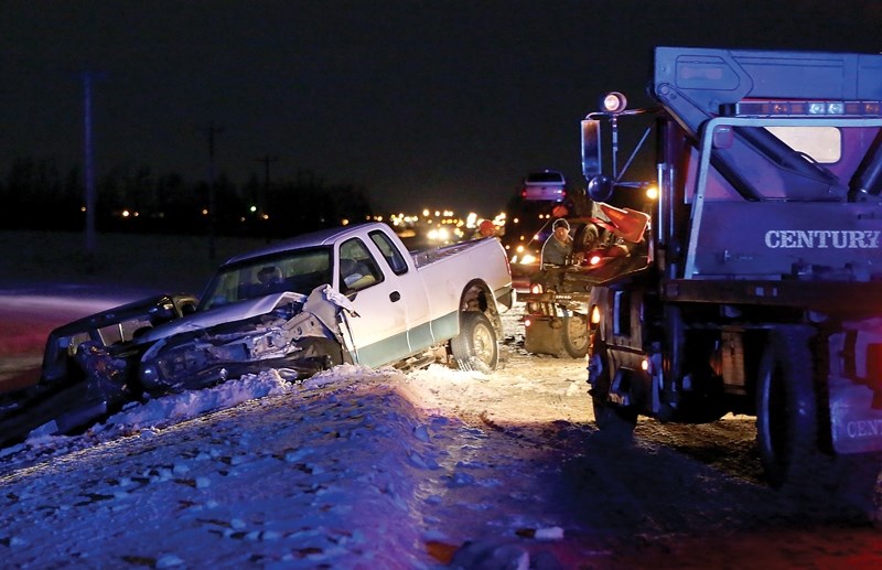 A tow truck pulls the pickup involved in Monday evening’s fatal collision out of the ditch along Highway 44 at Township Road 602. The driver of the truck swerved to avoid a