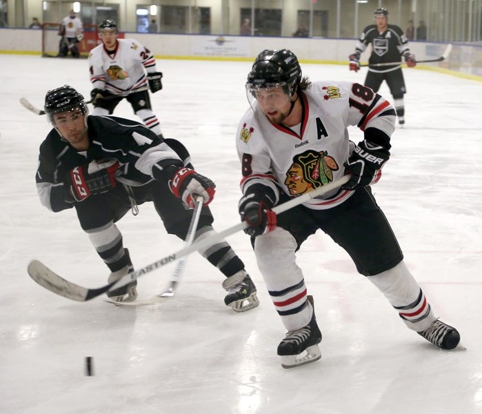 Westlock Warrior Mike Podruzny chips the puck on net past a Morinville Kings defender during the home side’s 4-3 win Saturday night. With the win, the Warriors advance to