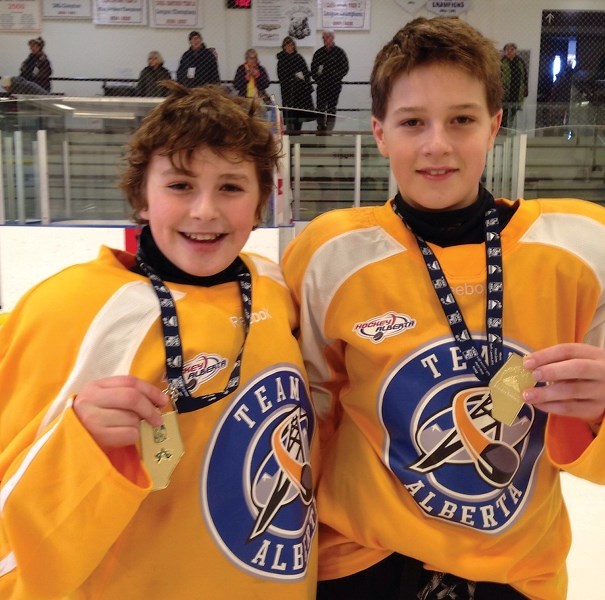 Blair Boulerice (left) and Jaden Senkoe with their gold medals won as members of the Zone 5 hockey team at the Feb. 6-9 Alberta Winter Games in Banff.