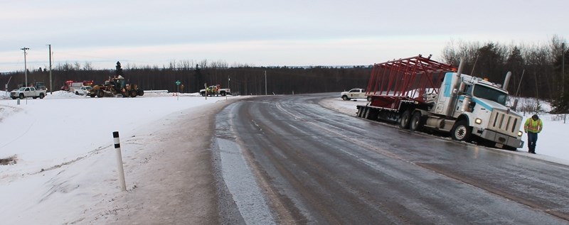 A truck waits to be pulled out of the shoulder after an incident at Highway 44 and RR 242 on Thursday morning, Feb. 19. The accident involved two trucks, one which