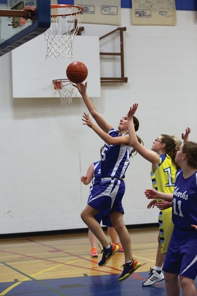 Saint Mary Shark Lilly Artemenko drives for a layup against Breton during the first game of the 2014 Cathy Mitchell Cup in Westlock. The Sharks lost the game 72-48, but went