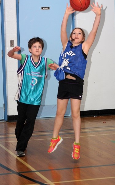Dapp School’s Hailey Verbeek (left) and Busby School’s Caitlyn Potts compete for a rebound during the Elementary School Basketball Tournament at Dapp School last Friday. The