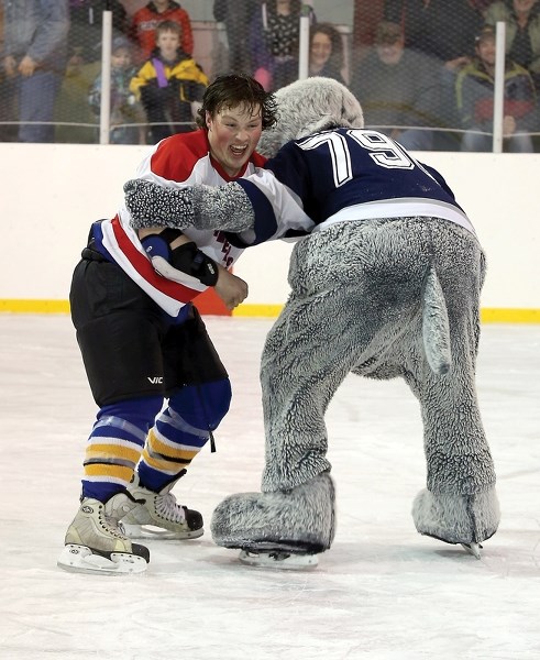 Fawcett Funtimer Cody Borris drops the gloves with the CFCW Critter Thursday night in Fawcett. The March 6 game was a fundraiser for the Fawcett Arena.
