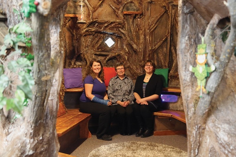 Duffy Fleming (above centre) sits inside the Fox Hollow treehouse at Westlock Elementary School with her daughters Renee Fleming (left) and Adrienee Finnegan. The treehouse