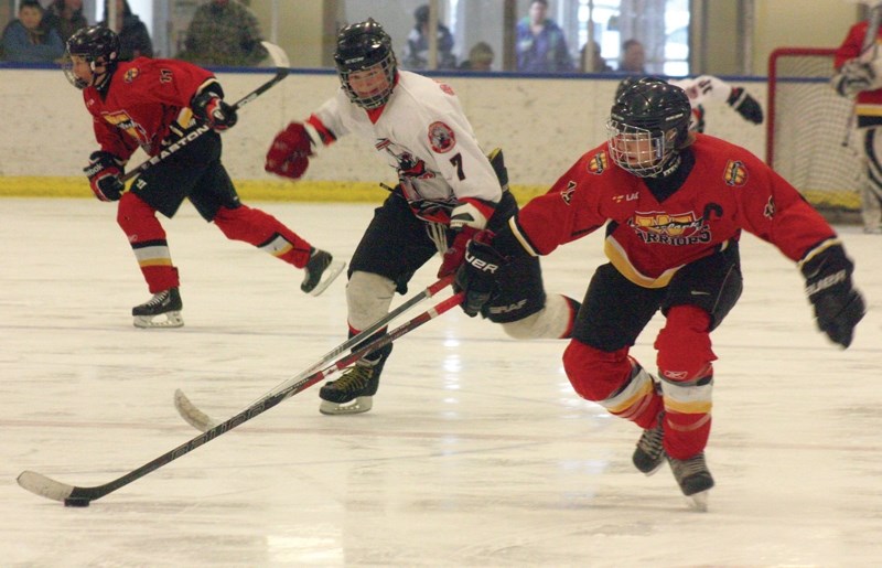 Westlock Warriors’ team captain Ethan Brost nabs a pass during the Warriors’ 6-1 loss to the Vegreville Wranglers on Saturday afternoon. The Wranglers went on to win