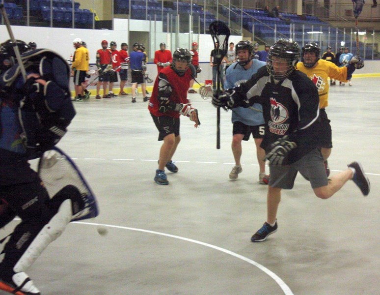Derek Tymko (wearing black) takes a shot on goaltender Troy Desranleau during a Westlock Junior Rock practice last Thursday. The final cuts have been made, and the squad’s