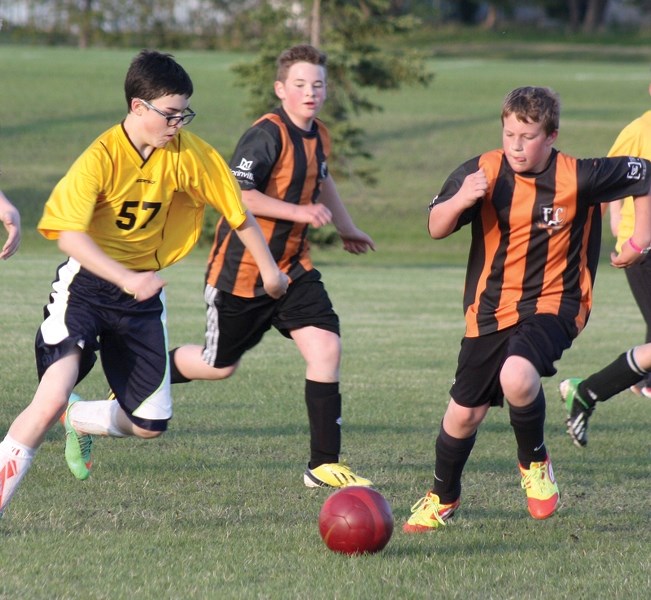 Westlock’s Konnor Smerychynski works past some Morinville defenders during Friday night’s match at the Westlock Elementary Field. The U14 team went 2-1-1 over their three-day 