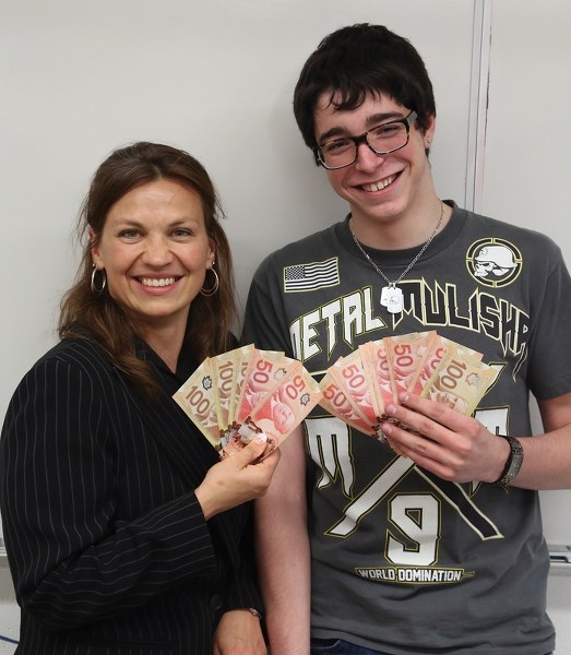 Budding entrepreneur Chance Moon (right) hopes to keep some of those dollars when his jewelry design business takes off. Moon was a student in the Biz Kids program run by