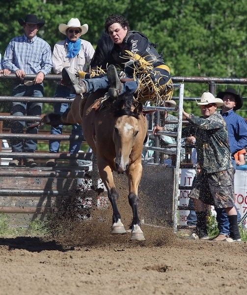 There was a lot of dirt flying at the June 14 Long Island Lake Amateur Rodeo. Pictured is Joe Borris holding on for dear life in the bareback riding event.