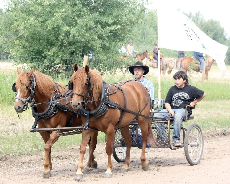 Jeff Hale (left) and Joe Lachance led the pack of horses and wagons leaving the Echo Lake Campground last Sunday morning.