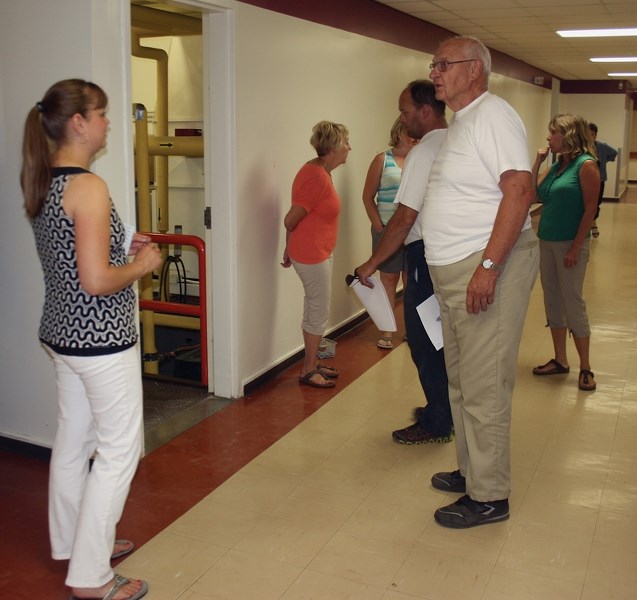 Pembina Hills board chair Kim Webster speaks with Werner Frose during a July 16 tour of W.R. Frose School in Fawcett at a public meeting about the fate of the school building.