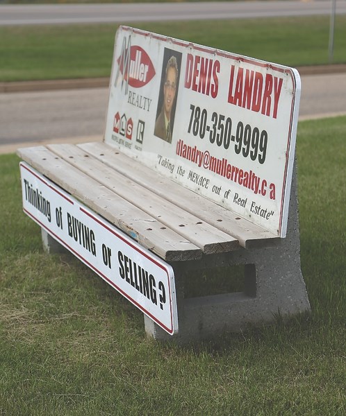 Benches around town that have doubled as billboards, similar to this one, are on their way out as a result of a dispute between Seven Angel Signs owner Brad Boutin and the