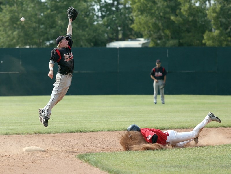 Red Lions shortstop Jordan Brand leaps for the throw from catcher T.J. Oliwa to try to stop a Camrose Axeman from stealing second in Game 2 of the teams’ playoff series at