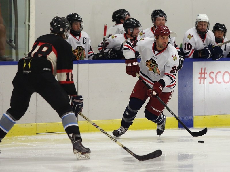 Kyle Chipchura, centre with the Arizona Coyotes and former Westlock minor hockey player, evades a Westlock Warrior defender during the Aug. 23 exhibition game between the