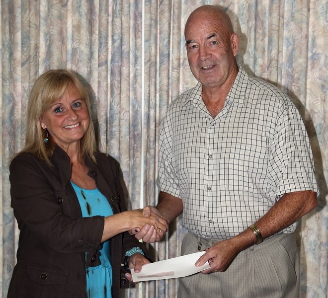 Westlock County reeve Bud Massey presents Hope Resource Centre executive director Sylvia Yoder with a cheque for $10,000 on Aug. 20.