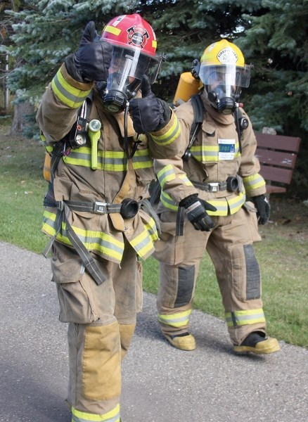 Westlock-area firefighters Mike Walmsley (left) and Joanne Plamondon did the Sept. 14 Terry Fox run in full gear.