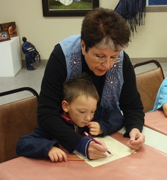 Patricia Mackonka helps Zachary Siemens with an art project during Alberta Culture Days at the Westlock Art Gallery last Saturday afternoon.