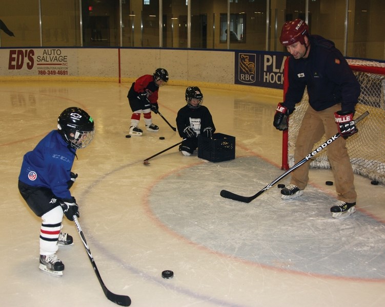 Connor McCoy tries to shoot past Shane Madsen as he tends goal during the &#8220;I Love Hockey &#8221; event on Saturday afternoon at the Rotary Spirit Centre. Connor was