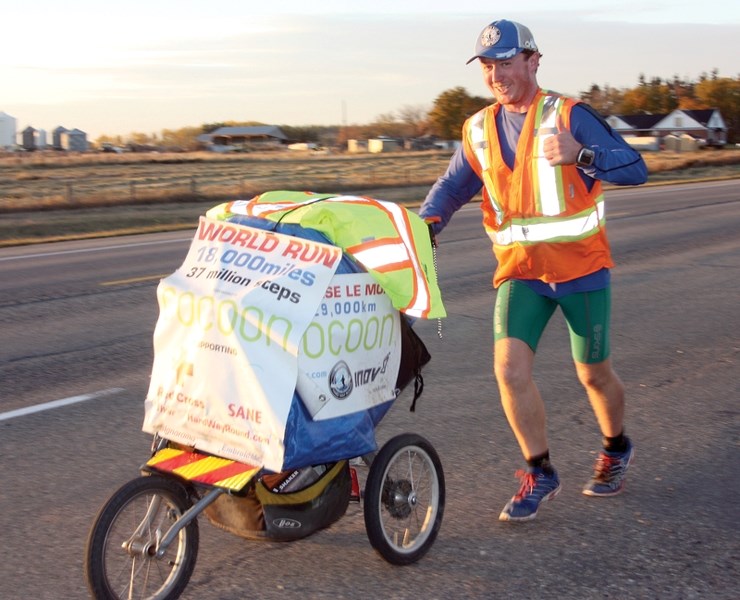 British ultramarathon runner Kevin Carr jogs down the side of Highway 2 near Legal late Thursday evening. Carr passed through the Westlock area last week on his more than