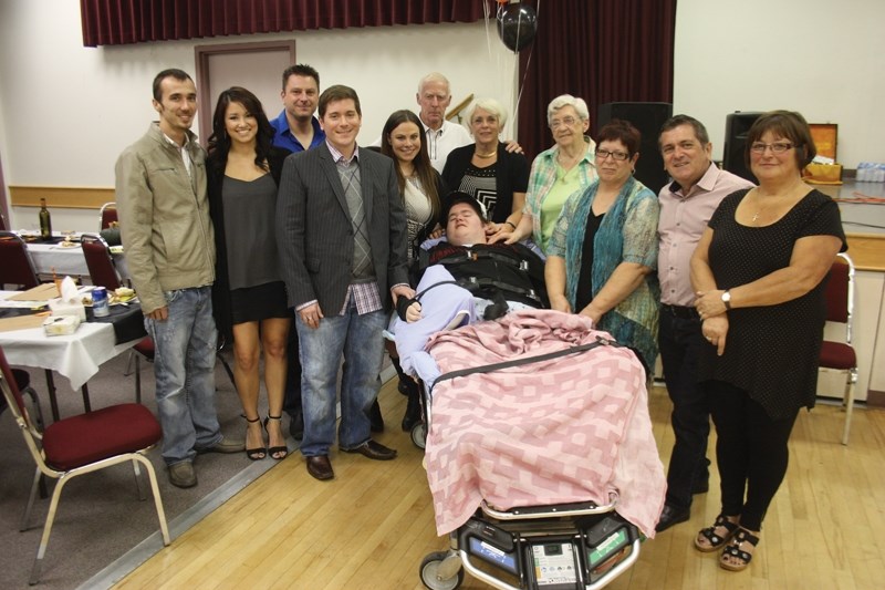 Lance McNamara was surrounded by friends and family at the Memorial Hall last Saturday night. From left: Cousins Matthew and Maggie Stoby, his brother’s partner Mark Nevell,