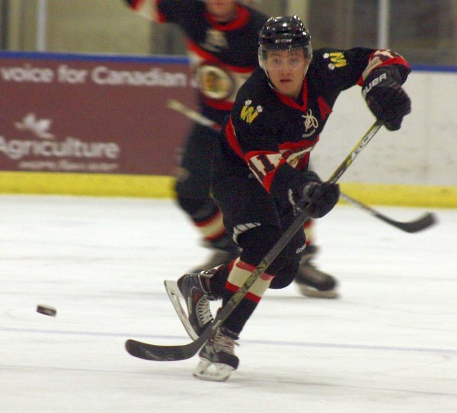 Evan Kuhar catches a pass during a Saturday-night victory over the Rocky Rams. The Westlock AA Warriors remain undefeated in the North Central Hockey League.