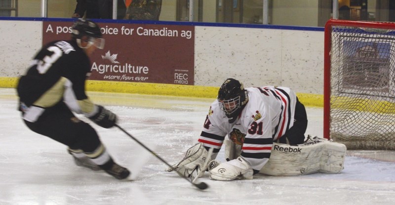 Warriors goalie Chris Kuhar puts an end to a breakaway by Devon Baron forward Aaron Fedyk during the club’s 6-5 Nov. 14 victory at the Spirit Centre.