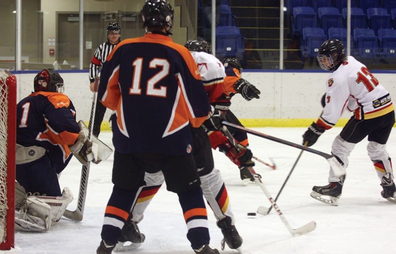 Westlock Warrior Ethan Brost looks for an opportunity to score through some heavy traffic in front of the Calmar net during a 6-4 win at the Westlock Rotary Spirit Centre