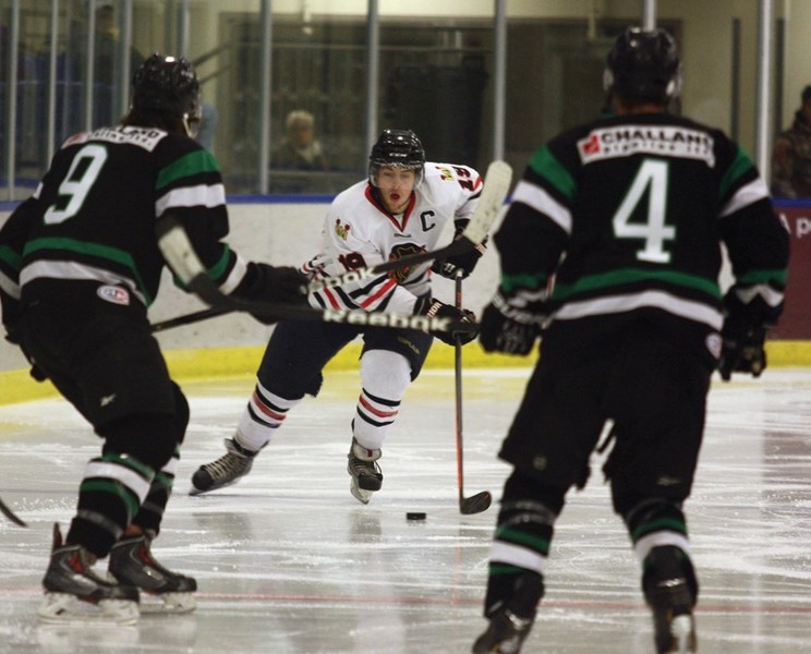 Westlock Senior Warriors captain Mike Ivey weaves his way through some Rocky Rams defenders during an 8-6 win in Westlock on Saturday night. The Warriors won both their