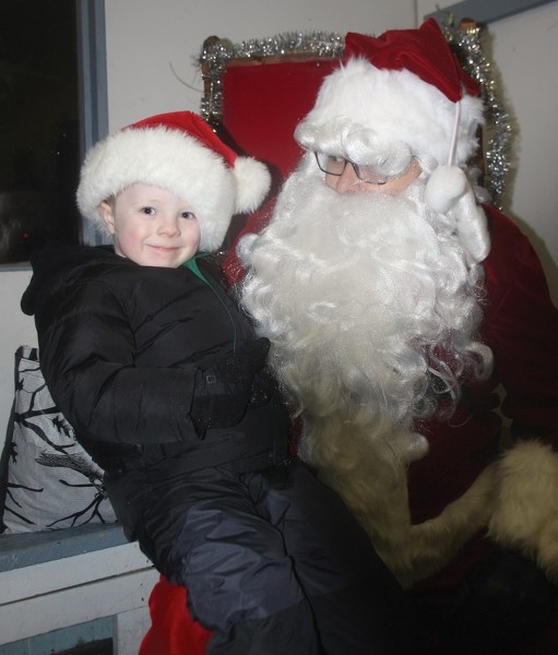 There was lots to see an do at the Clyde Christmas Parade last Sunday. Jax Fradette, 4, enjoys a visit with Santa Claus who arrived earlier on a parade float.